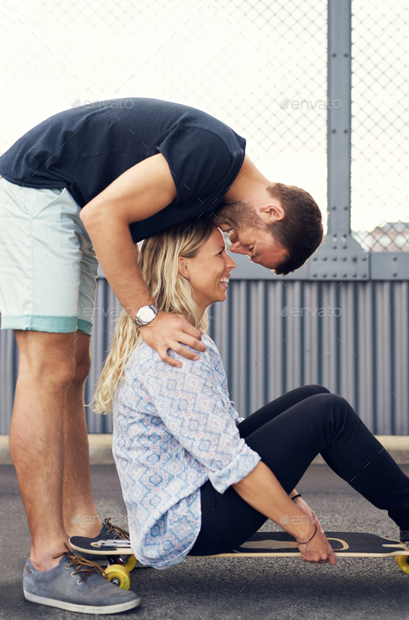 Man leaning over woman kissing her - Stock Photo - Images