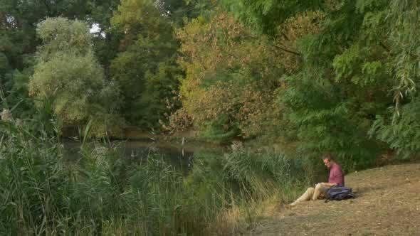 Man Sitting at The Lake Looking in Front of Him alt