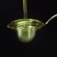 Olive Oil Poured On a Spoon Over Black Background - VideoHive Item for Sale