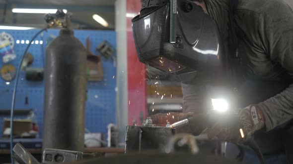 Welding Process. Welder In Helmet Works, Worker Works In The Auto Workshop alt