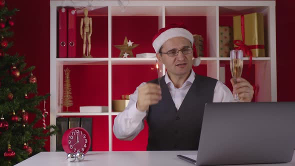 Happy 40s Corporate Employee in Santa Hat Participates in Online Christmas Party