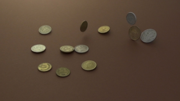 Coins Falling Onto a Group Of Other Coins alt