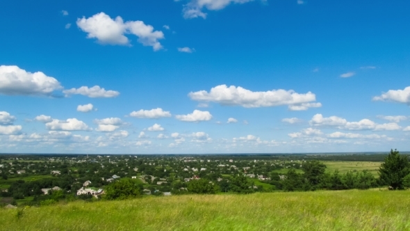 Landscape, Clouds Moving Over a Field With Trees. alt