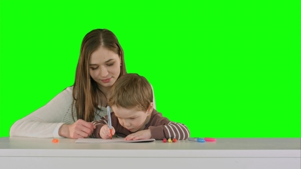 Mom And Kid Boy Painting Together On Table On a alt