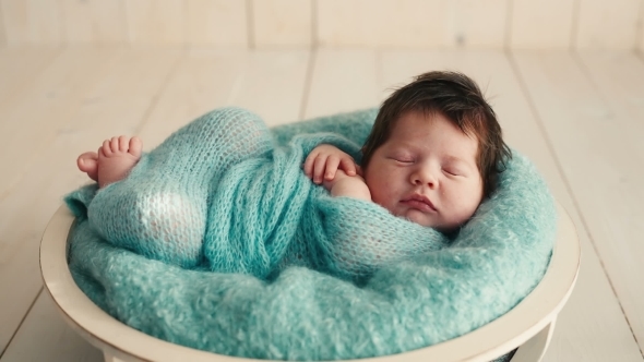 Cute Newborn Baby Sleeping On a Blanket