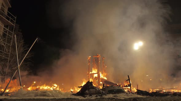 A fire among palm trees alt