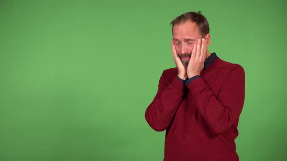 A Middleaged Handsome Caucasian Man Cries  Green Screen Background