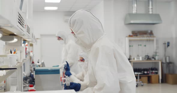 Biotechnology Scientist Wearing Ppe Suit Researching in Equipped Laboratory alt