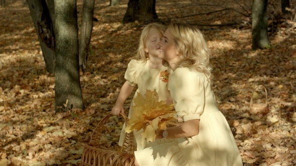 Happy Young Mother With Daughter In Autumn Park alt