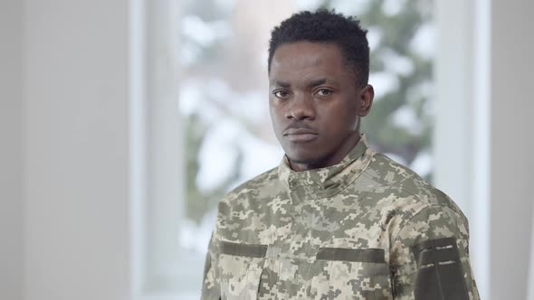 Young Handsome Recruit Turning to Camera and Saluting Indoors alt