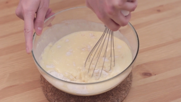 Young Housewife Using Dough Whisk