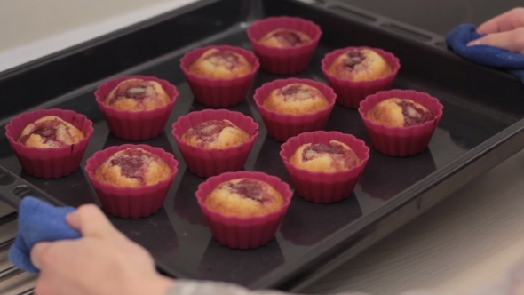 Girl Gets Ready Muffins Out Of The Oven