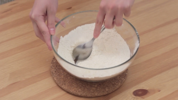 Woman Whisking Batter In Kitchen