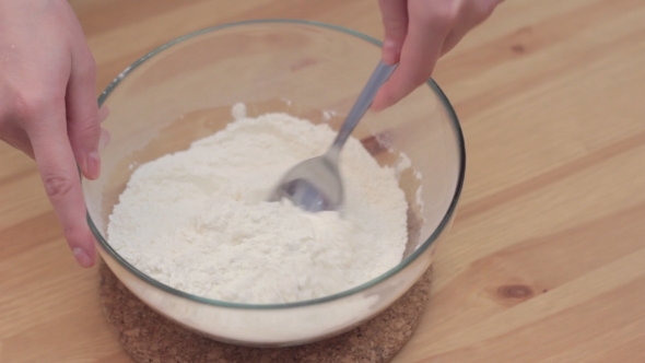 Woman Whisking Batter In Kitchen