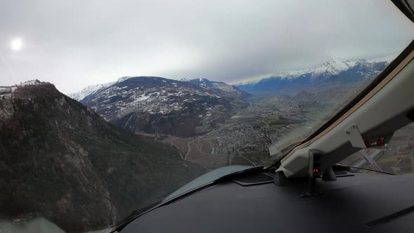 Pilots view of jet approaching airport in Sion Valley in the alps alt