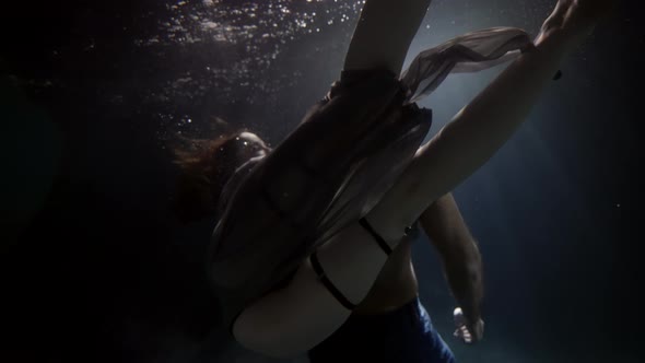 A Man's Muscular Back Is Touched Passionately By a Woman Underwater Lovers Deep Inside on a Dark alt