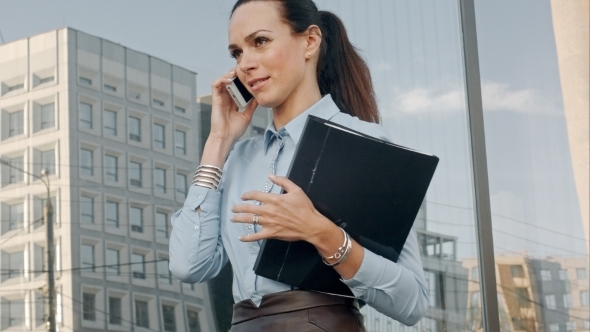 Happy Smiling Businesswoman Speaking Over Mobile alt