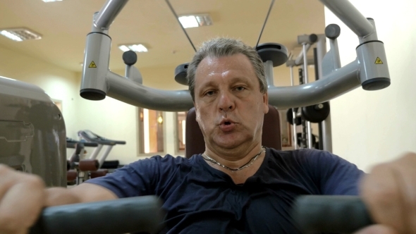 Man Exercising On Special Sport Equipment alt