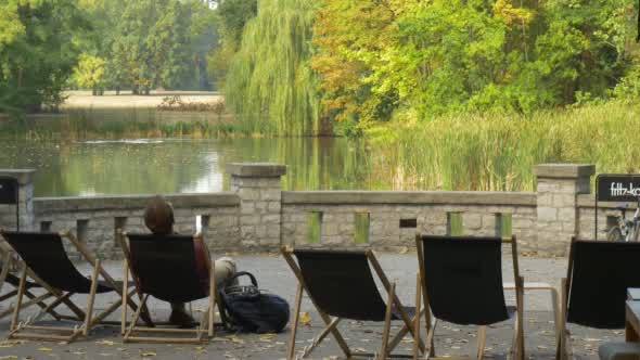Man In Maroon Shirt And Beige Pants Leans Back In alt