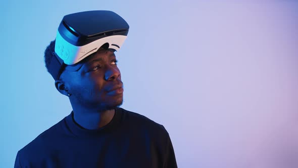 AfricanAmerican Guy with Virtual Reality Glasses on His Forehead alt