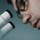 Young Doctor  Looking Through The Microscope - VideoHive Item for Sale