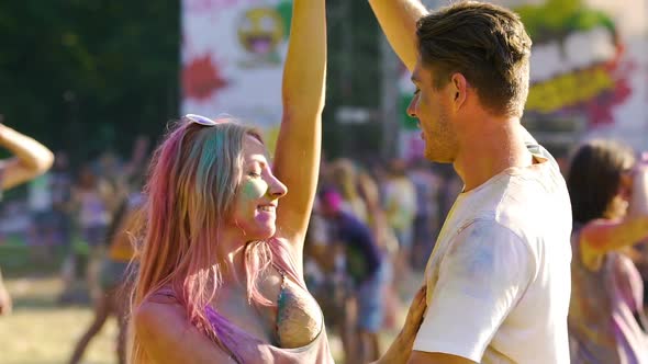 Happy Boyfriend and Girlfriend Dancing at Outdoor Concert Together Slow-Motion alt