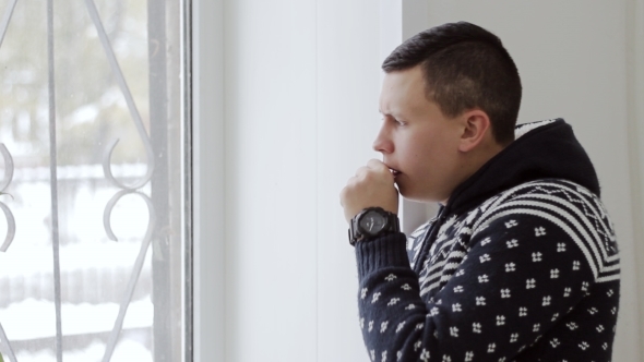 Man In Warm Sweater Coughs Standing At The Window