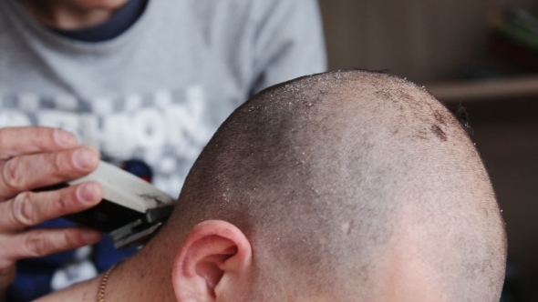 Mourning Man Getting His Head Shaved
