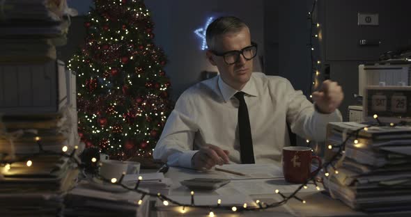Sad corporate businessman working on Christmas day, stressful job concept