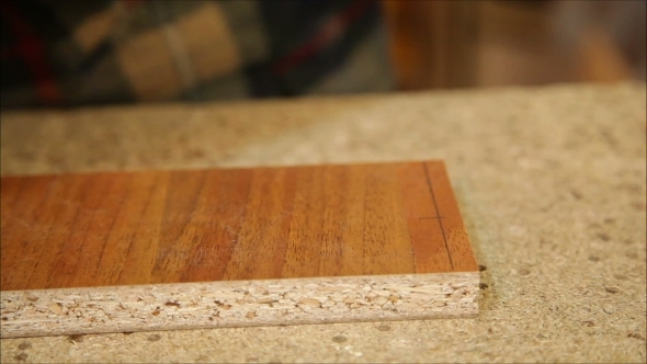 Worker Processes a Wooden Board