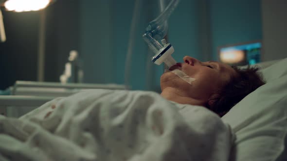 Patient Breathing Oxygen Mask in Hospital Closeup alt