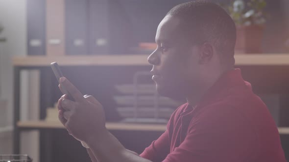 Close Up of Afro-American Male Office Worker Using Smartphone alt