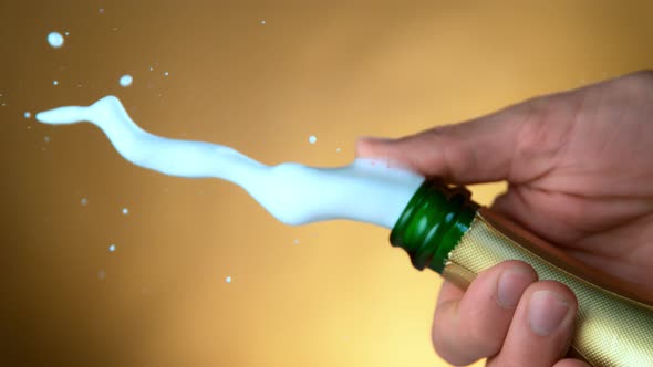 Super Slow Motion Shot of Champagne Explosion on Golden Luxury Background at 1000Fps alt