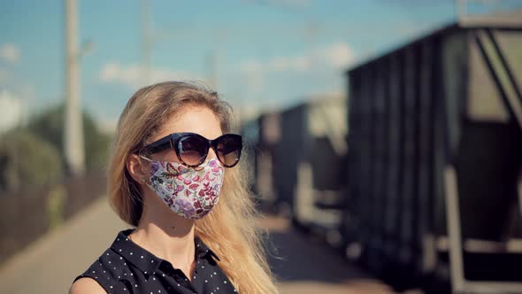 Female Waiting Train Wearing Protective Mask COVID19 Virus. Health And Safety Concept. alt