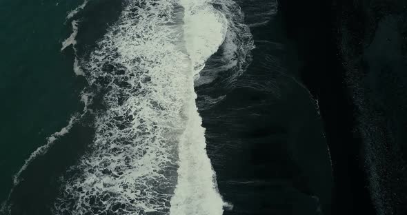 Strong Wave with Foam Coming To the Shore of the Black Volcanic Beach alt