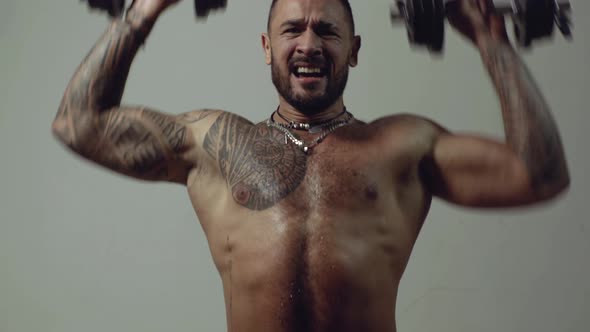 Handsome Power Athletic Man with Dumbbell. Strong Bodybuilder with Six Pack, Perfect Abs, Shoulders alt