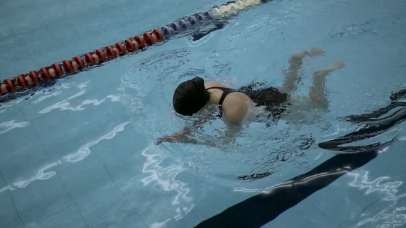 Young Amateur Woman Practicing Breaststroke In Swimming Pool, Slow Motion