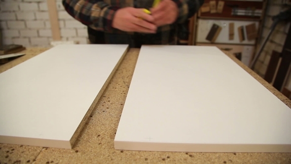 Worker Handles a Wooden Board 