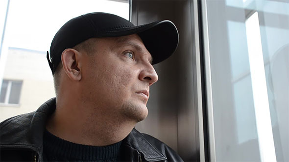 Man Riding in An Elevator alt