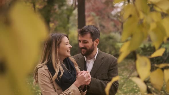 Handsome young couple walking in the autumn park