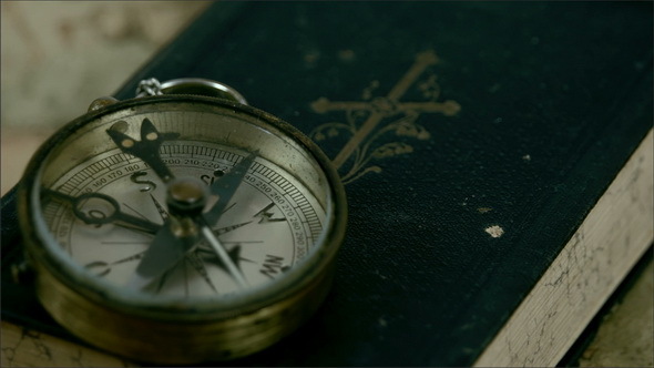 A Compass Pointing to North and the Bible