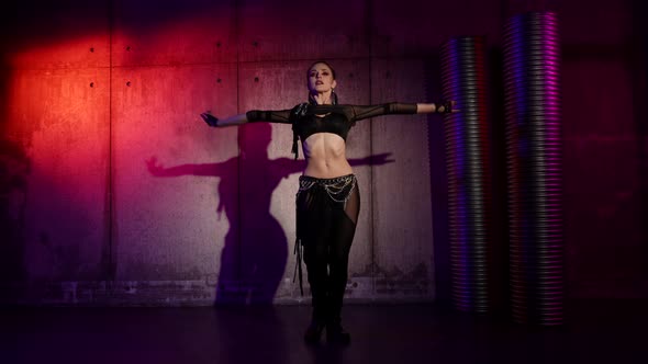 Contemporary Belly Dance of Young Sexy Woman in Dark Studio Lady is Wriggling Her Body and Hands alt
