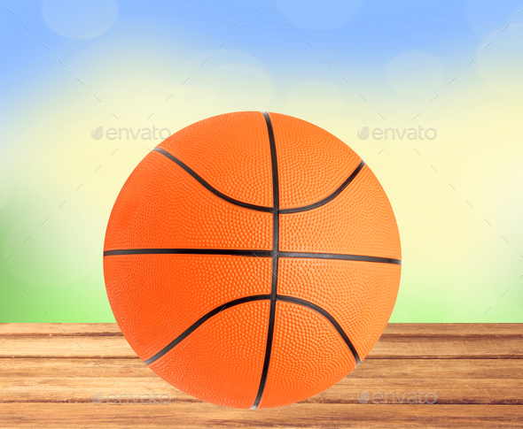 Basketball ball on the table over bight nature background