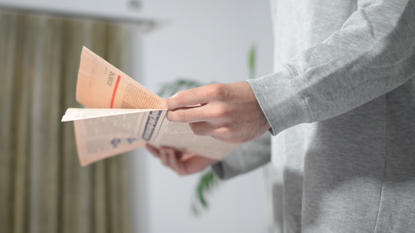 Man Reading Newspaper alt