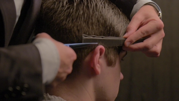 Man Getting a Haircut By a Barber
