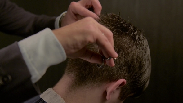 Barber Cutting Hair With Scissors