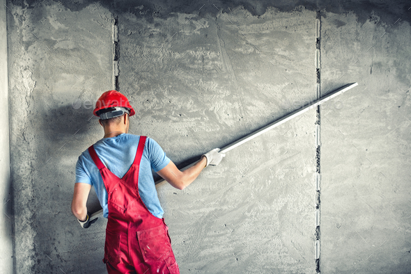 industrial worker with plastering tools renovating a house. builder worker plastering facade - Stock Photo - Images