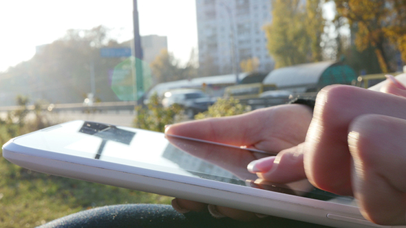 Woman Using Her Touchpad Near The Road