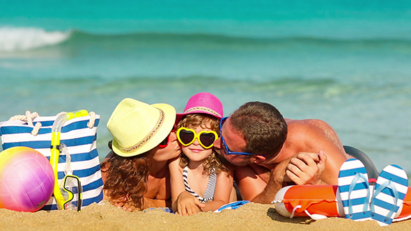 Happy Family Having Fun At The Beach