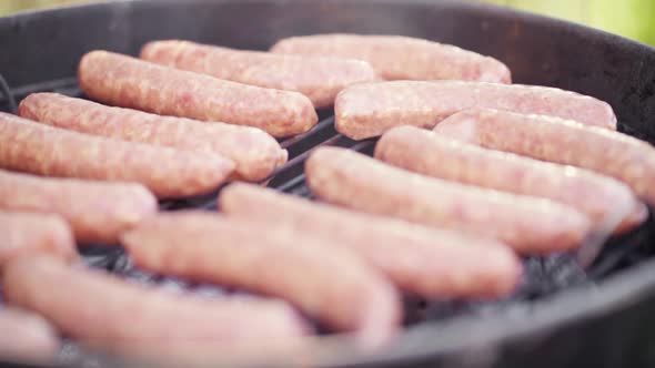 Slow Motion of Fresh Sausages Laid On a Smokey BBQ Grill alt